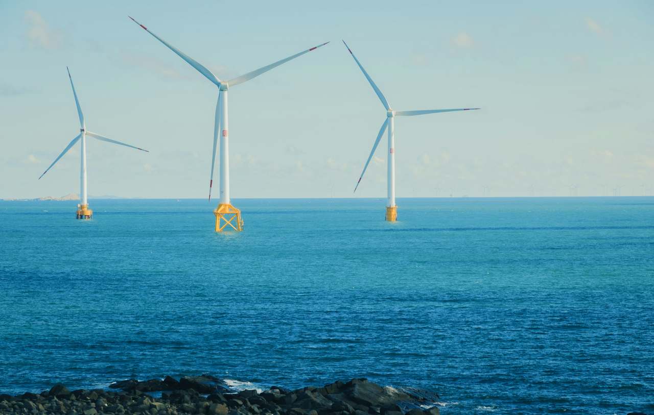 Installed offshore wind turbines on yellow foundation transition pieces
