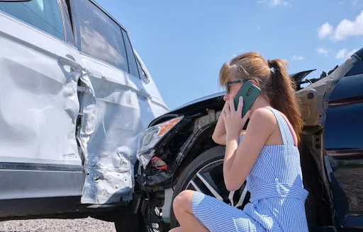 woman calling on phone after car accident - car accident