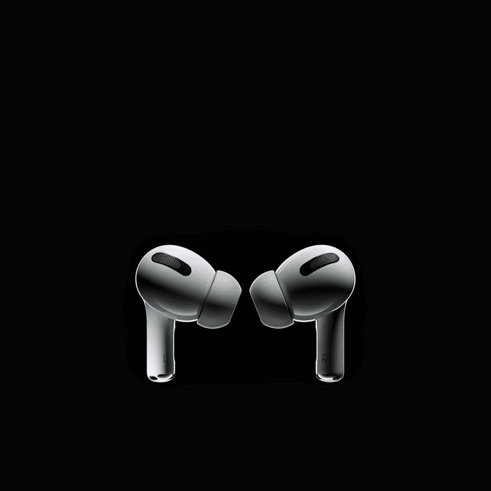 Close-up of stylish women’s chunky sneakers in soft green, beige, and orange tones, worn by a woman indoors with bright natural lighting.