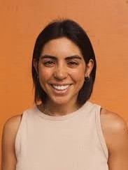 a close up of a white tiger near a building