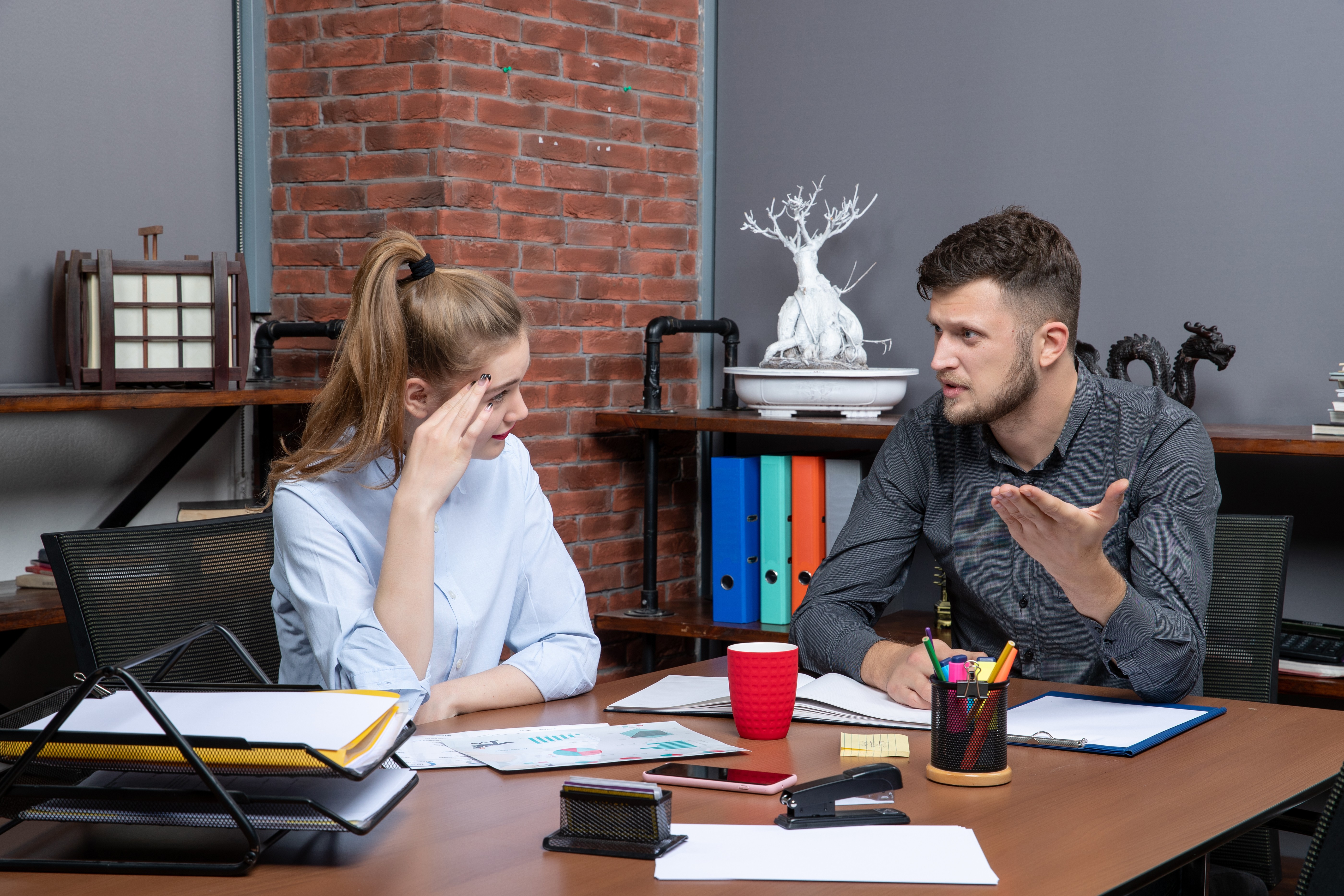 Manager scolding employee at workplace 