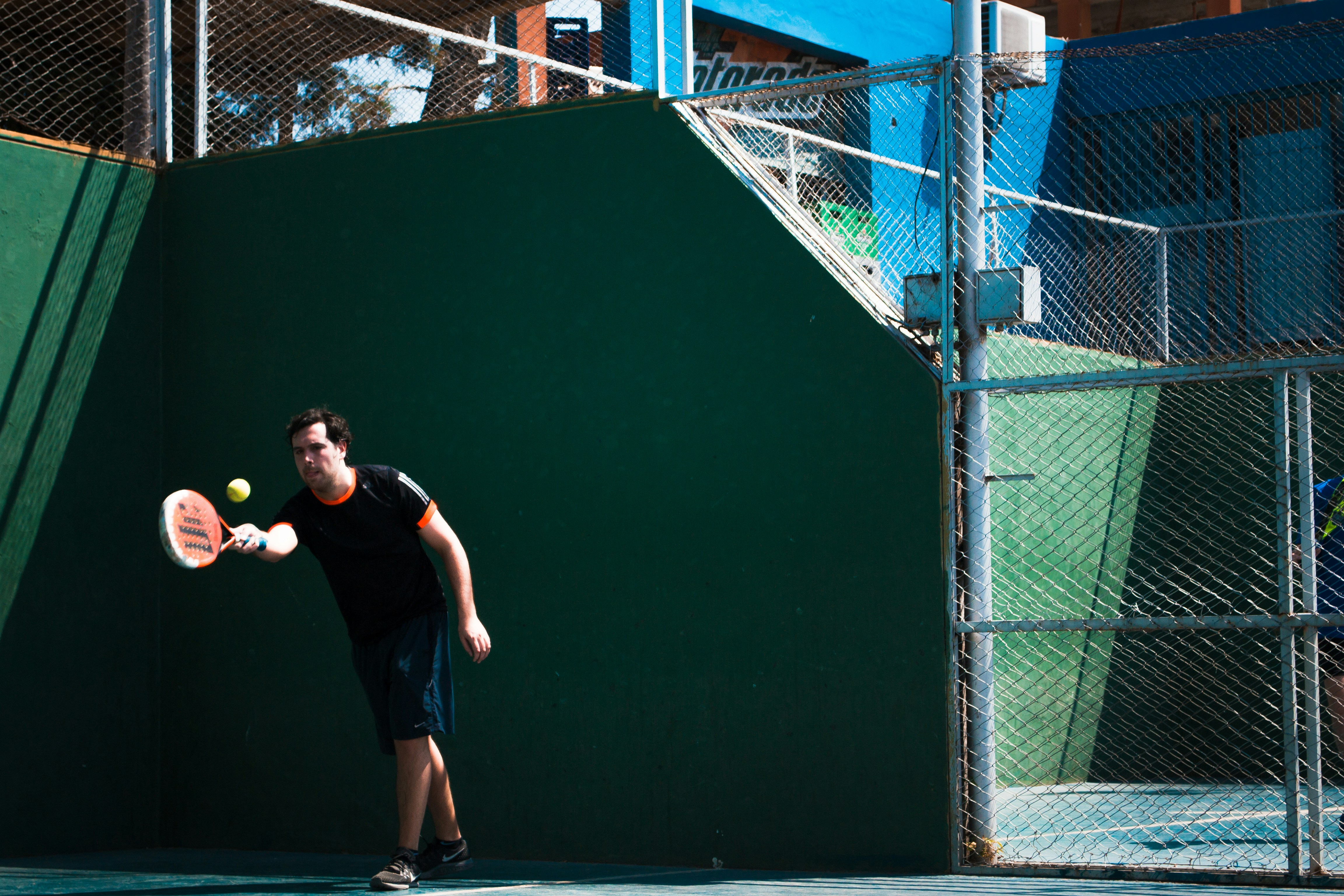 a man swinging a tennis racquet at a tennis ball