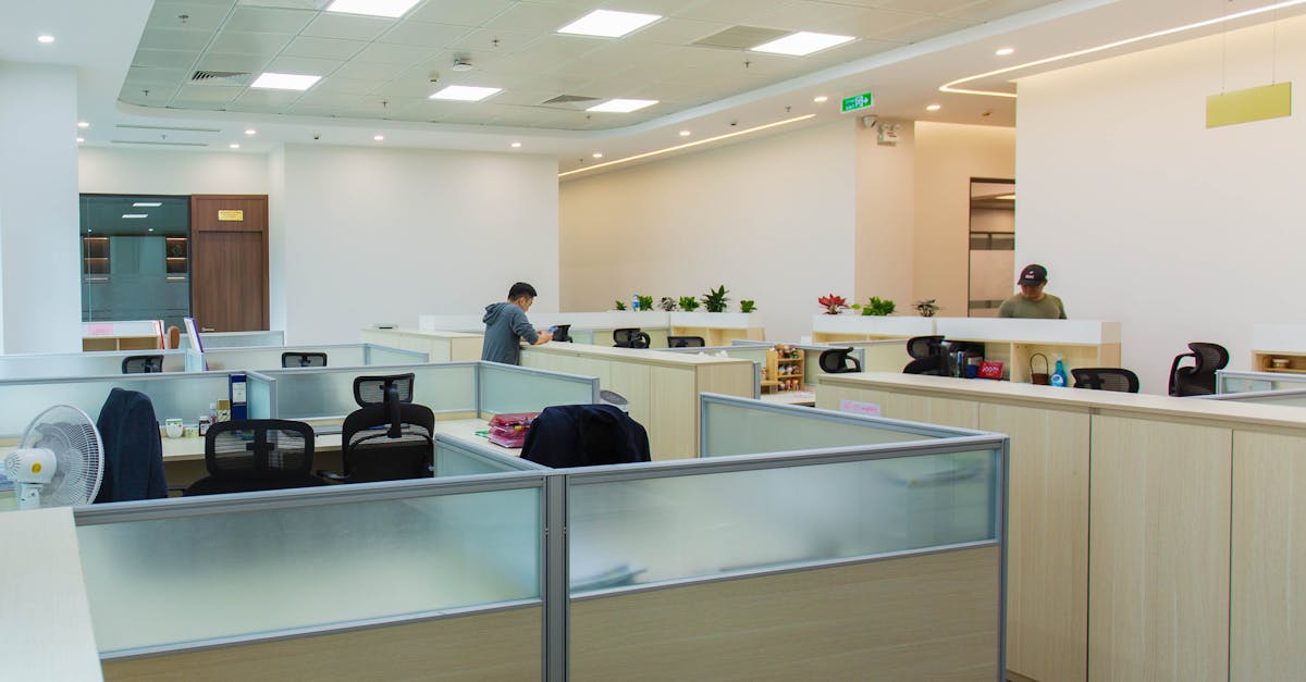 Spacious modern open office with workstations and natural lighting, optimal for productivity.