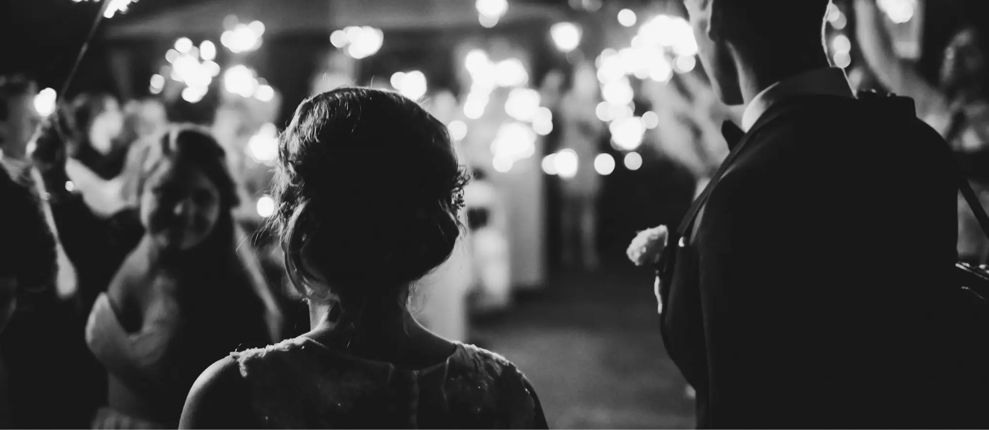 A joyful wedding celebration featuring dancing guests, a bride, and a groom, all expertly organized by a wedding planner.