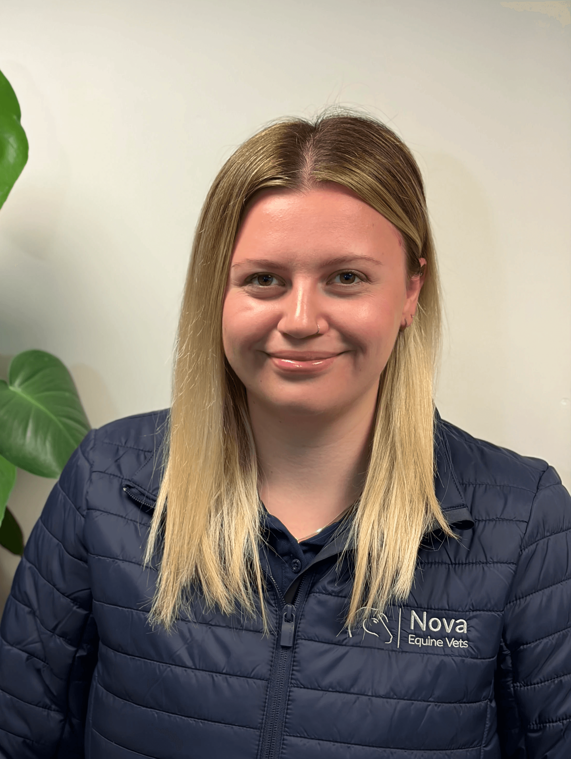 a man in a blue shirt smiling at the camera