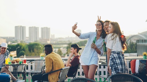 Friends taking a selfie on a rooftop party