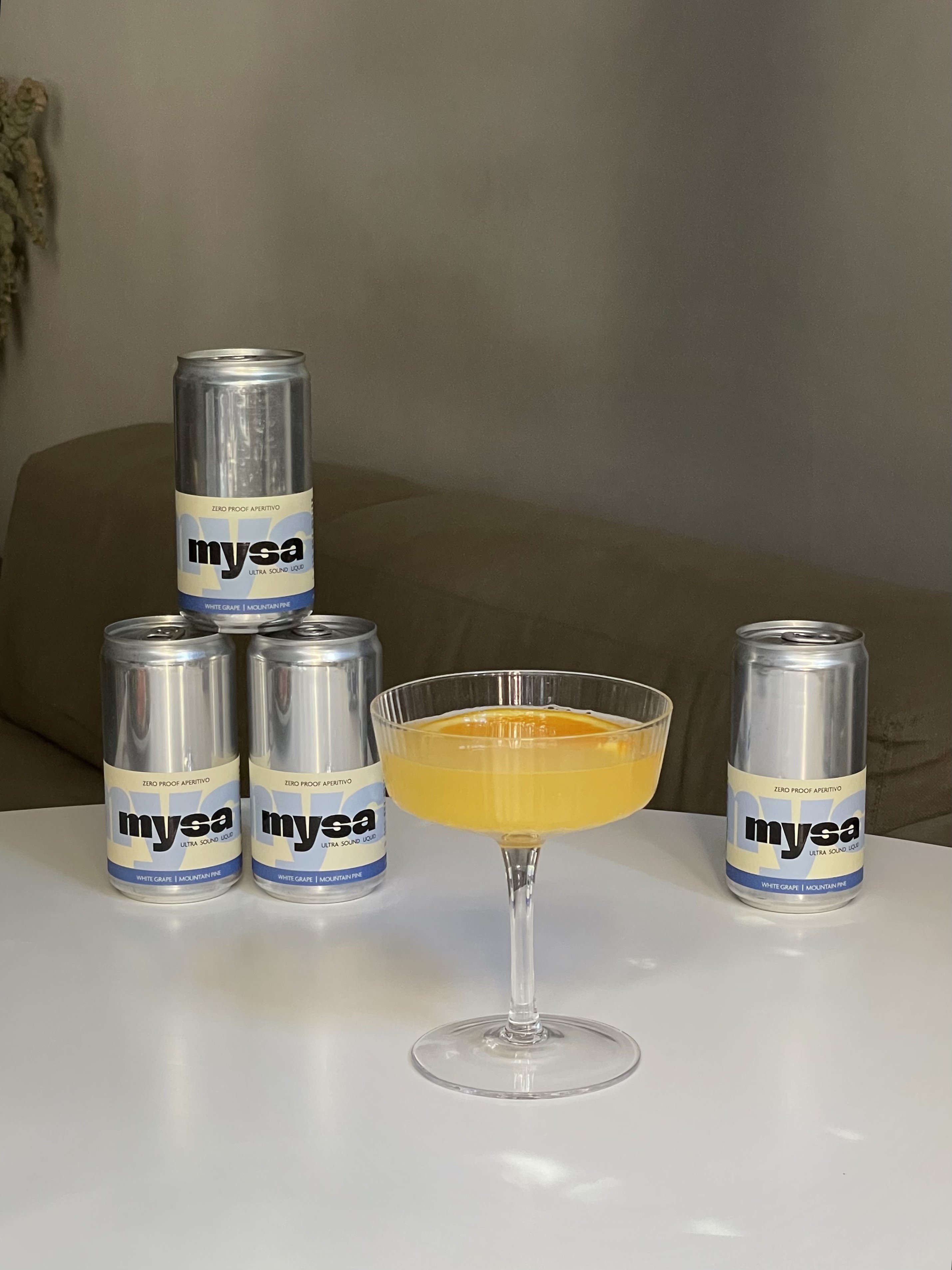 close-up of mysa served in a crystal coupe glass with a chili and square ice cube