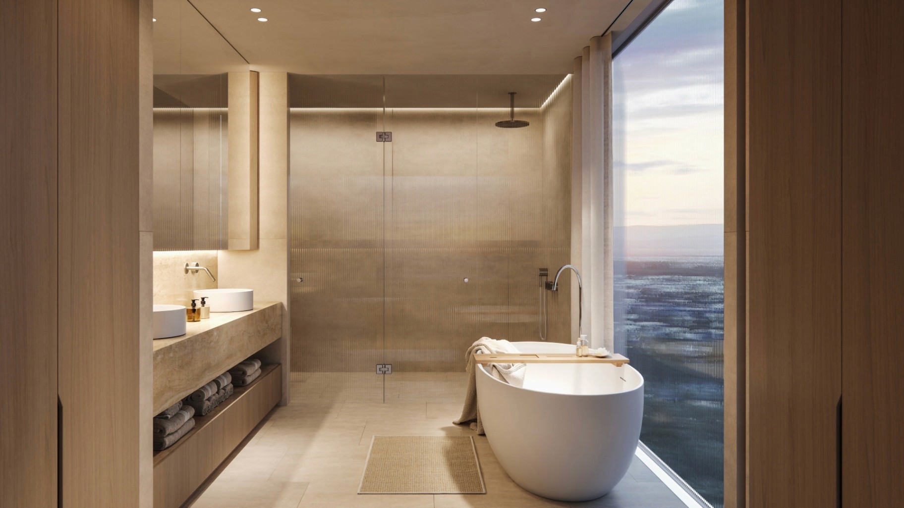 Luxury bathroom at Camilla Broadbeach with freestanding bathtub, stone finishes, and panoramic coastal views.