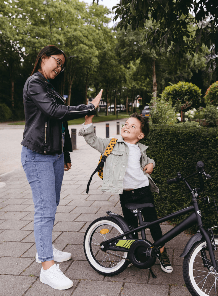 High five babysitter Angel with child from school