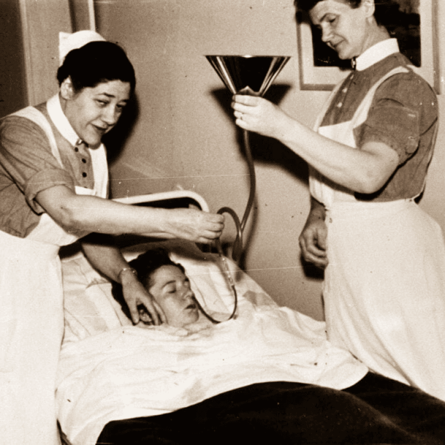 A nurse assists a patient.
