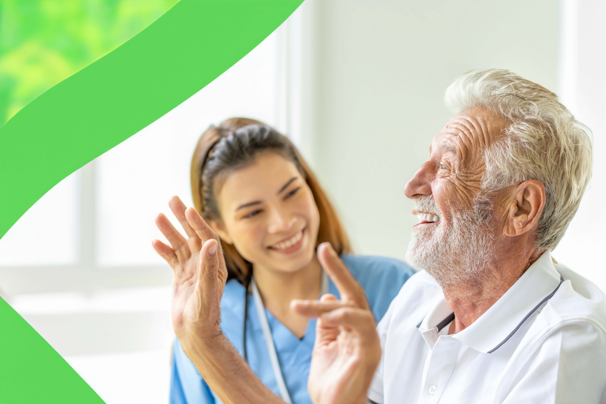 Smiling elderly man enjoying a playful moment with a friendly female caregiver in a bright, comfortable home setting, highlighting the warm, personal care services provided by North Pacific Home Care.