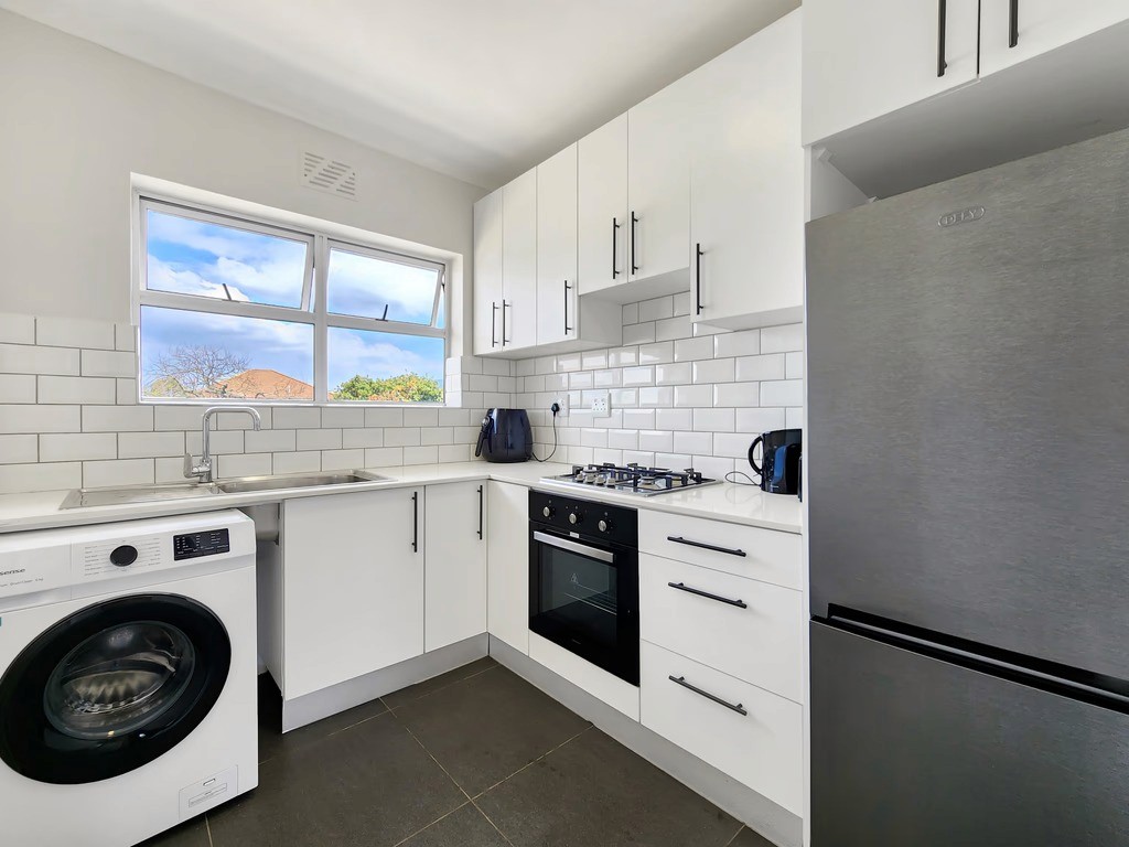 Spacious open-plan kitchen layout in a modern 2-bedroom apartment.
