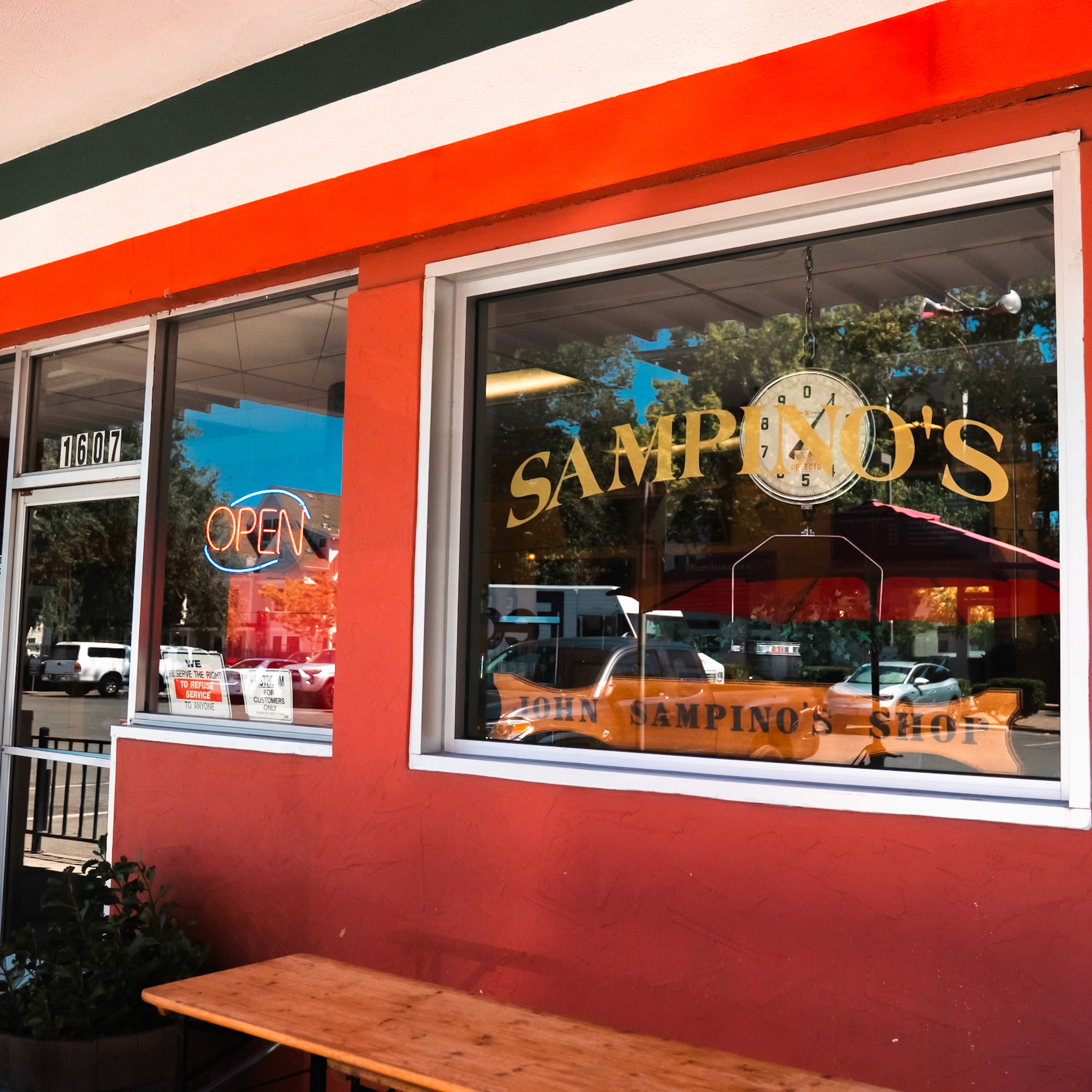 Sampino's Towne Foods red storefront with gold window lettering in downtown Sacramento
