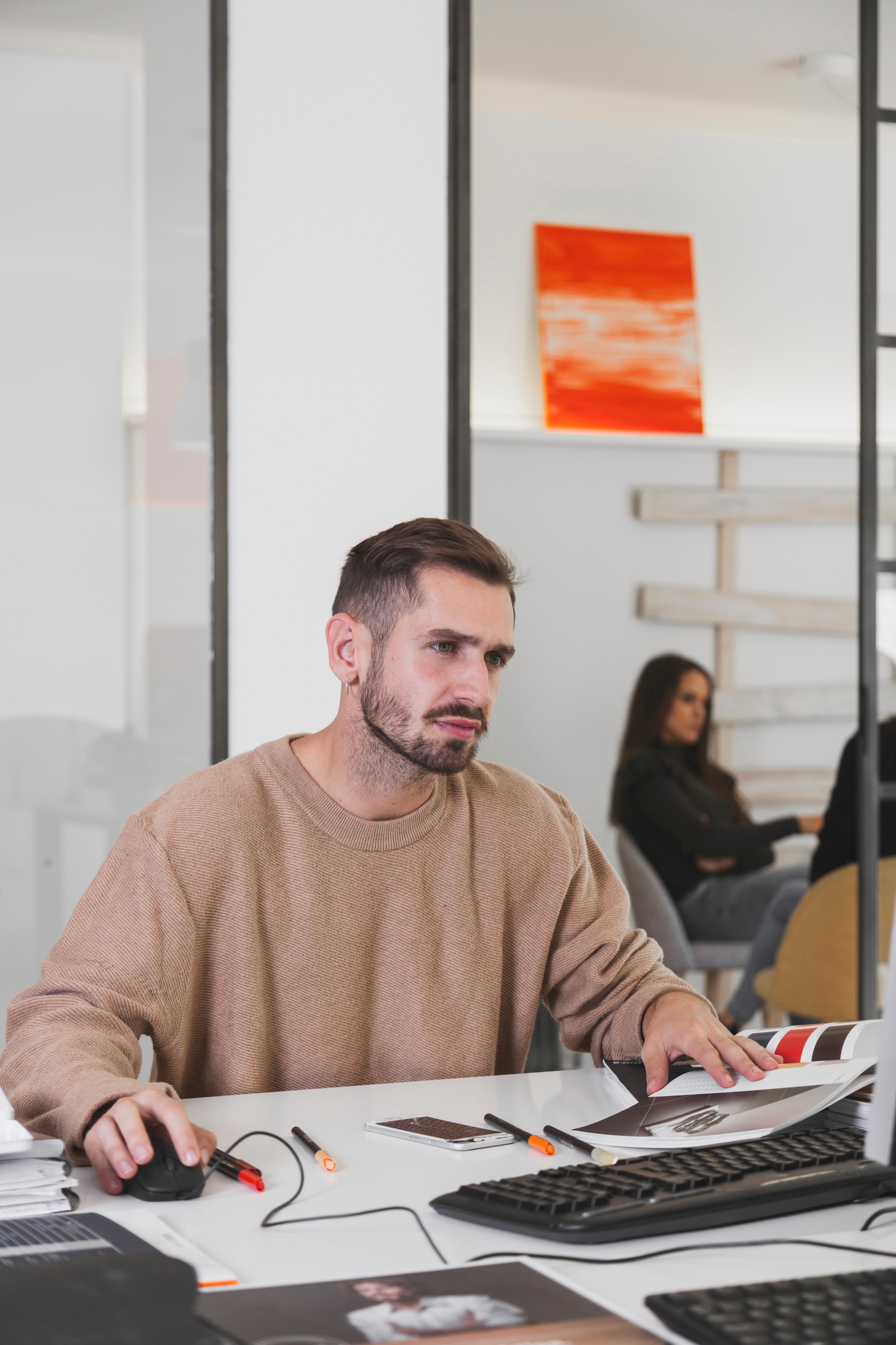 Man working at a computer in a modern office.