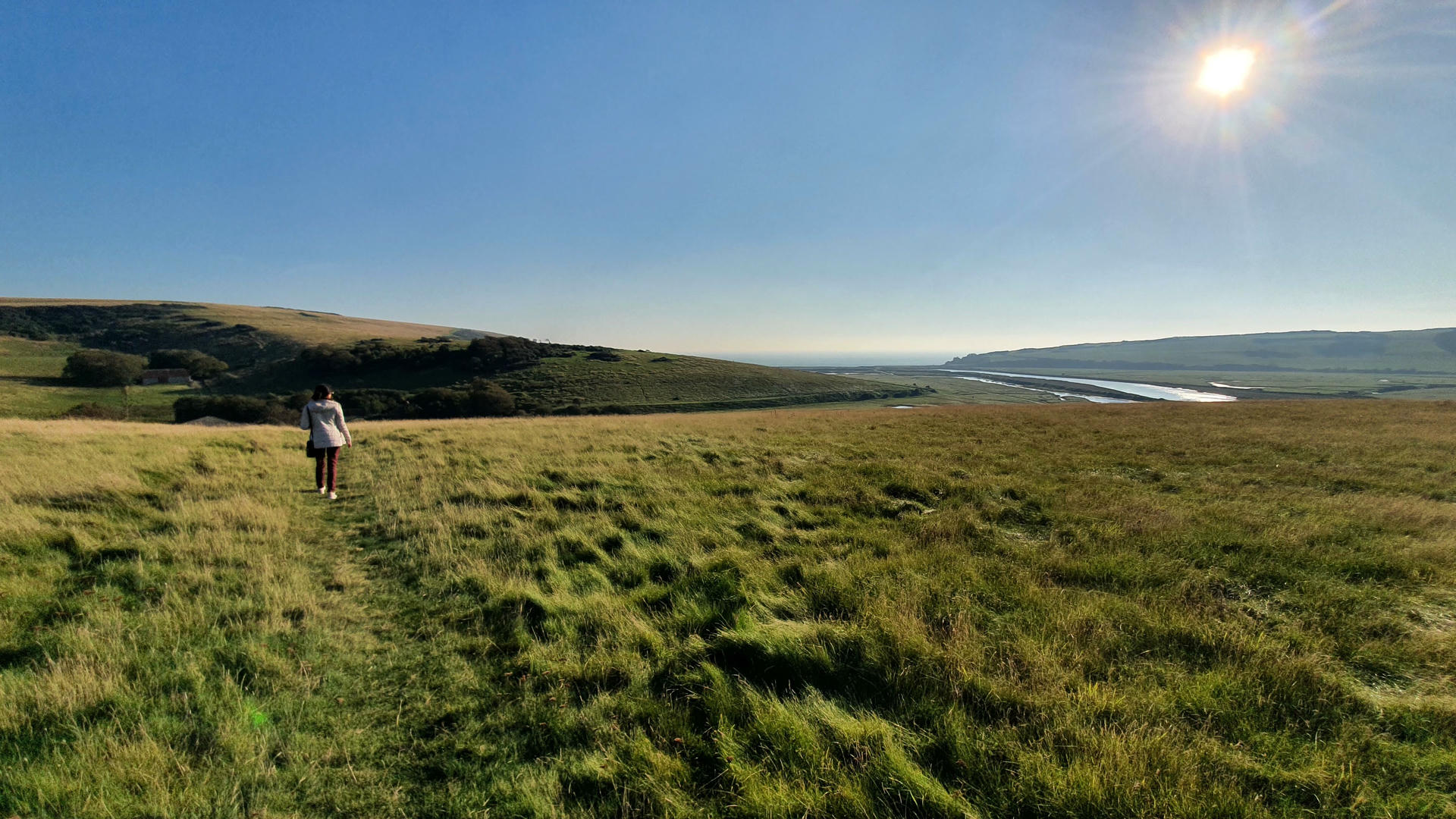 Samira standing at edge of cliff looking at clouds