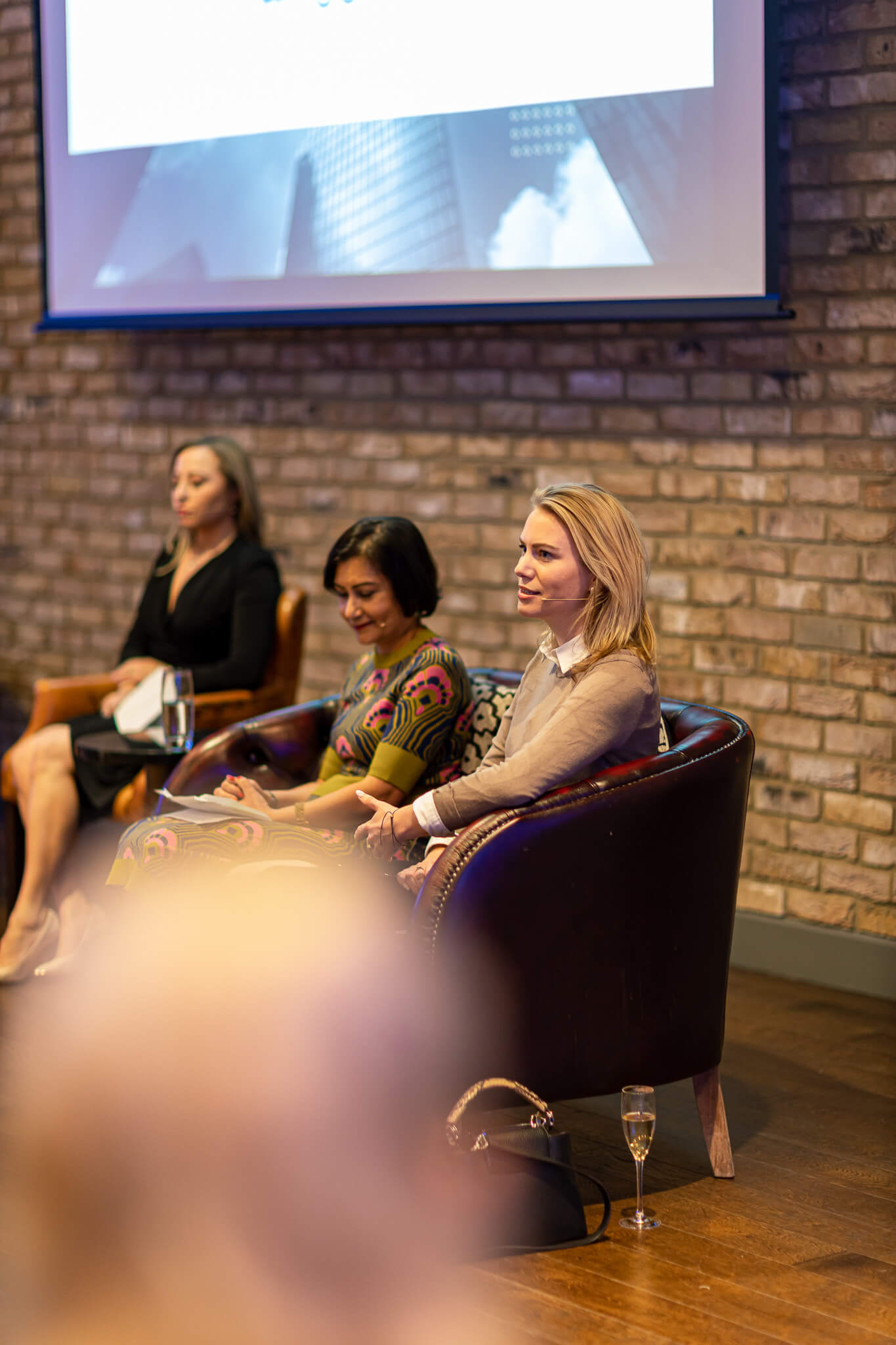 Women speaking during a finance and leadership panel at a live networking event