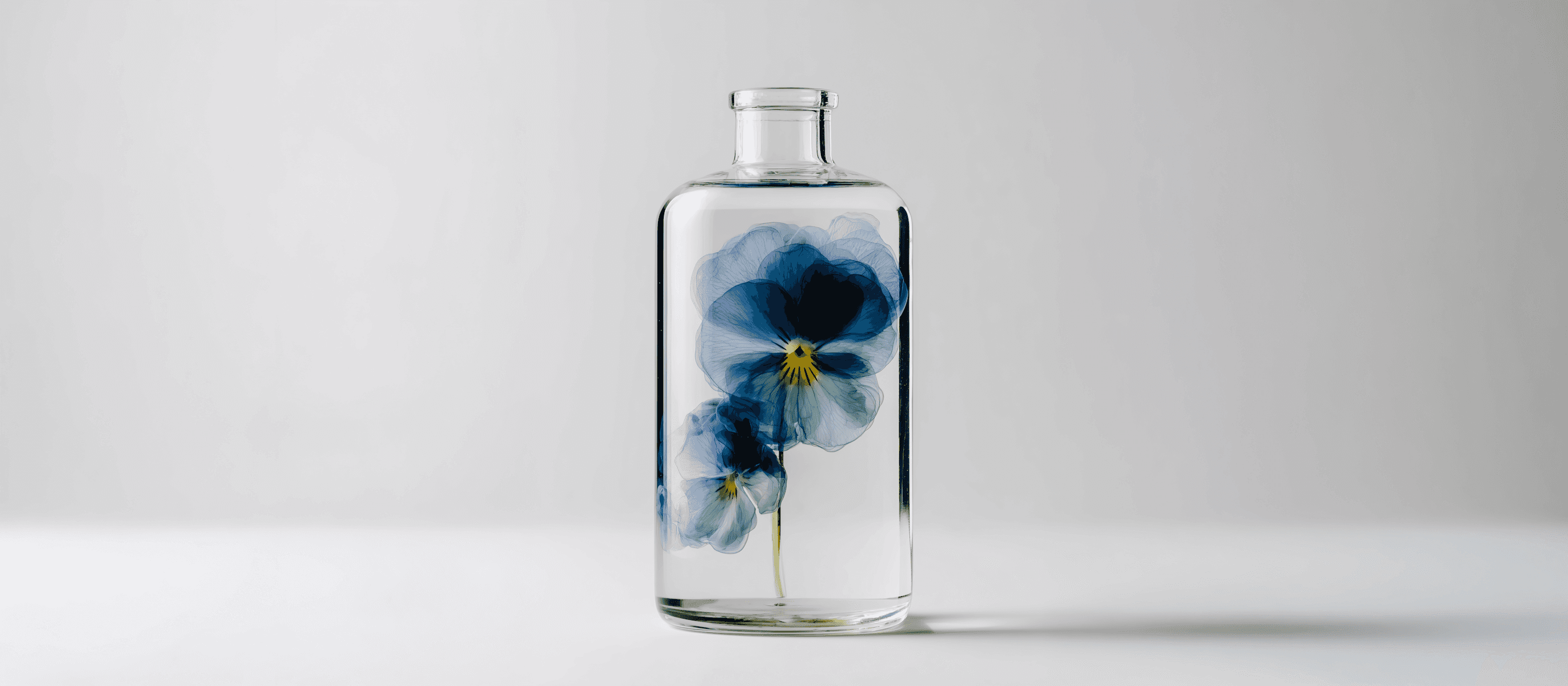Glass bottle with pansies