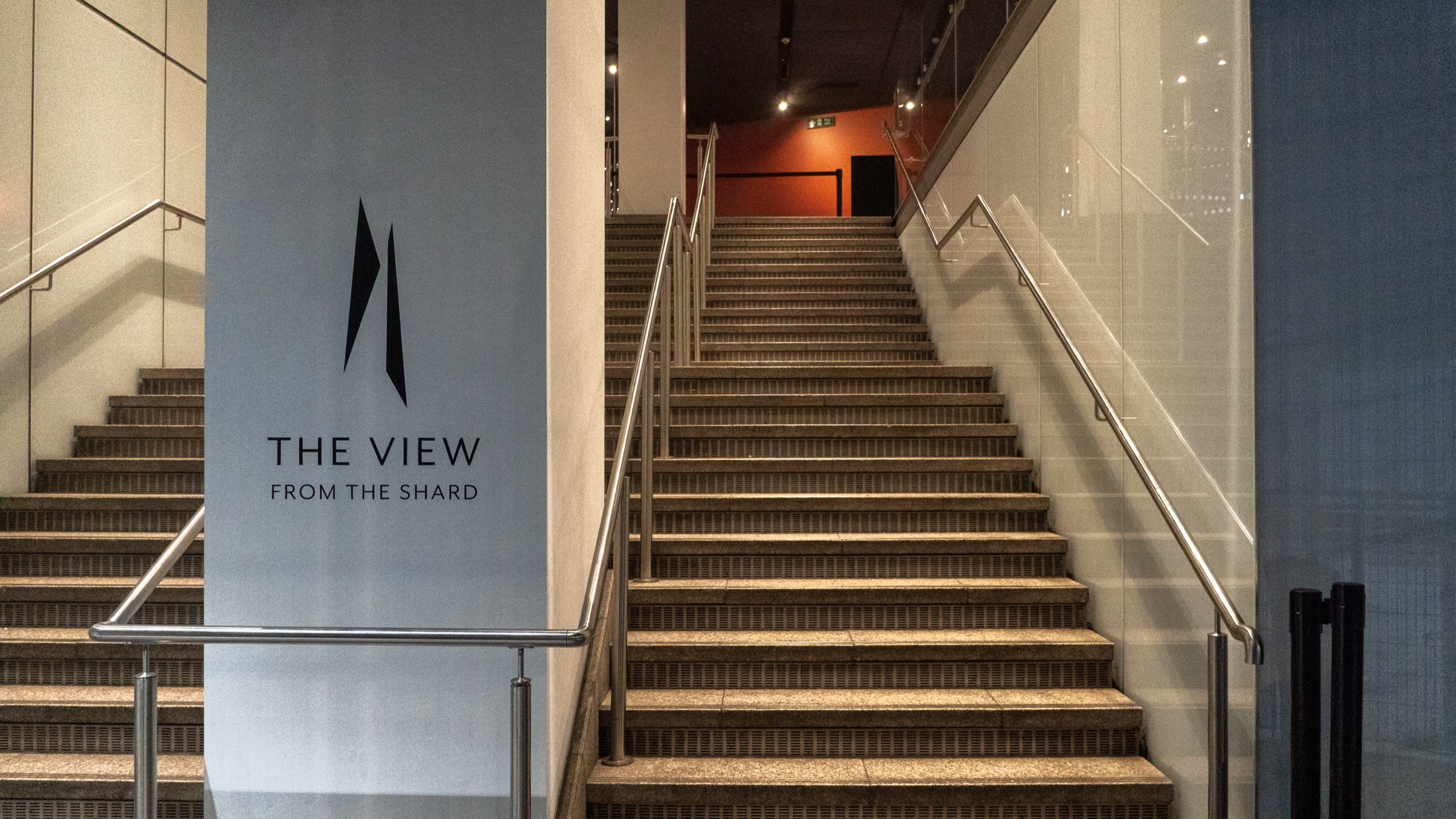 Two classic volkswagen beetles, one green, one cream.