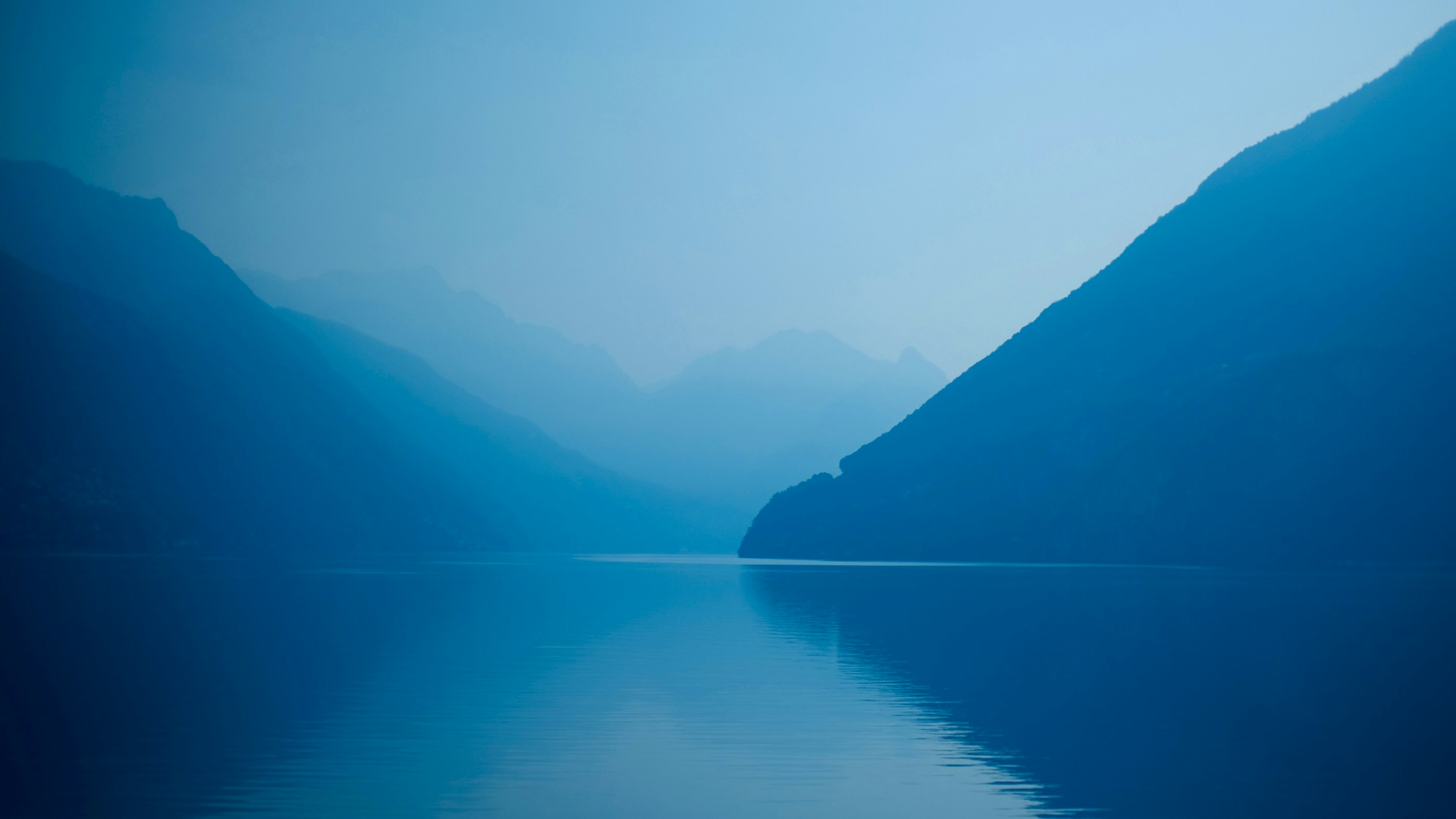 Fog forming over a mountain lake