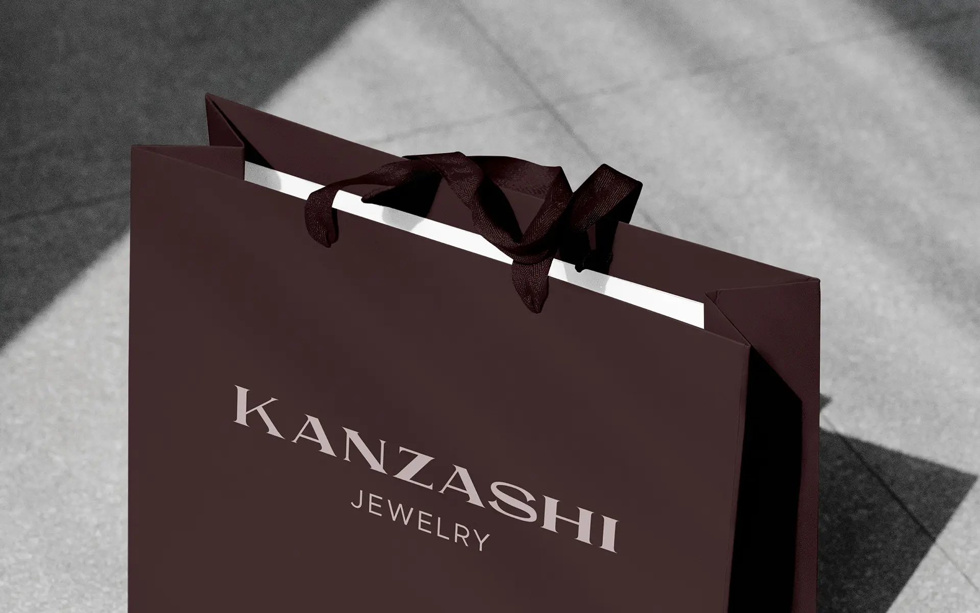Luxury shopping bag design for Kanzashi jewelry brand showing logotype on branded retail packaging