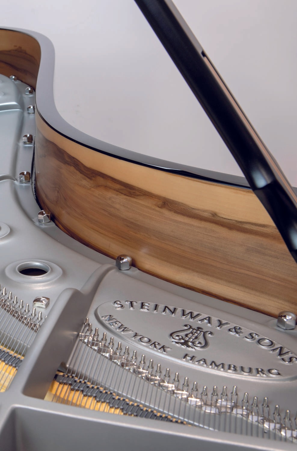A detailed shot of the piano’s interior, featuring amberwood accents and metallic elements, demonstrating the premium restoration quality.