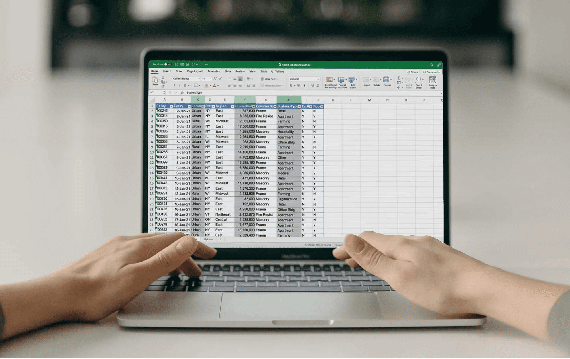  Person working on spreadsheet on laptop -  How to Automate Reconciliations in Excel
