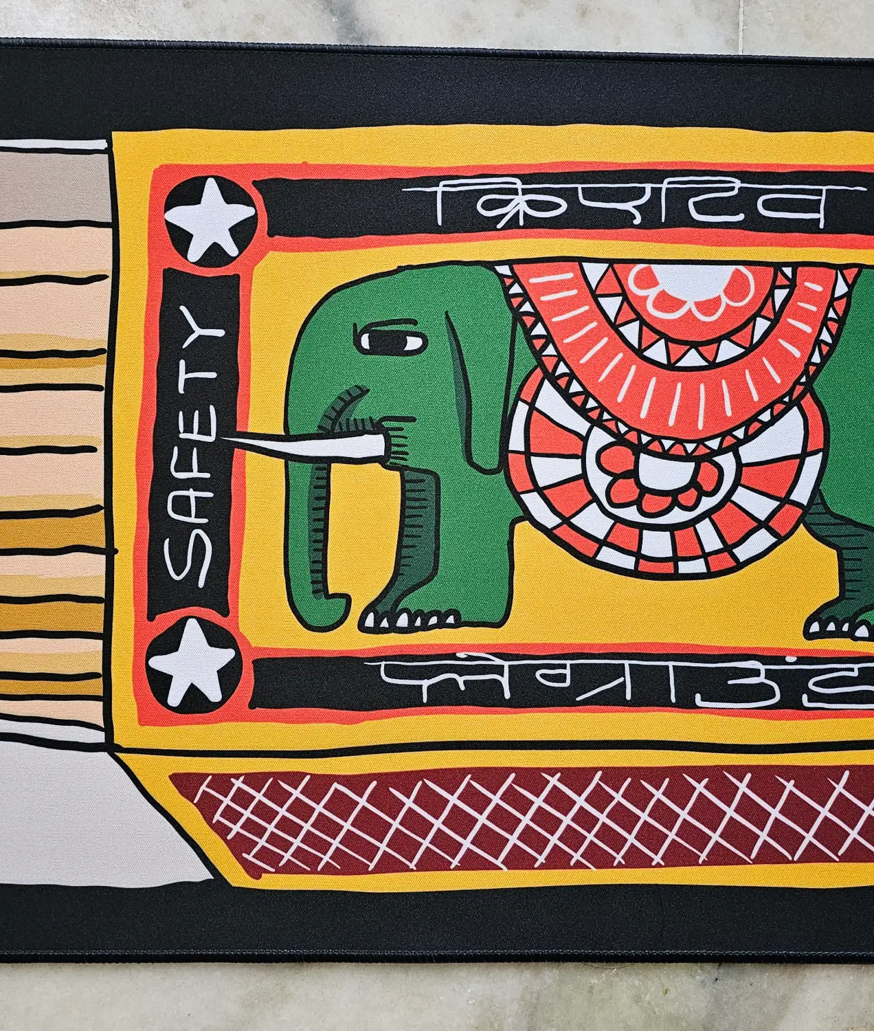 Matchbox deskmat close-up: the elephant label