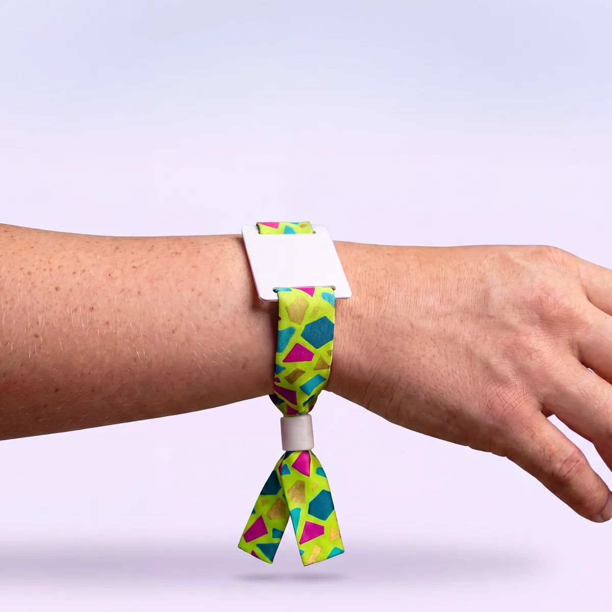 Custom printed RFID fabric wristband with white tag, worn on a wrist