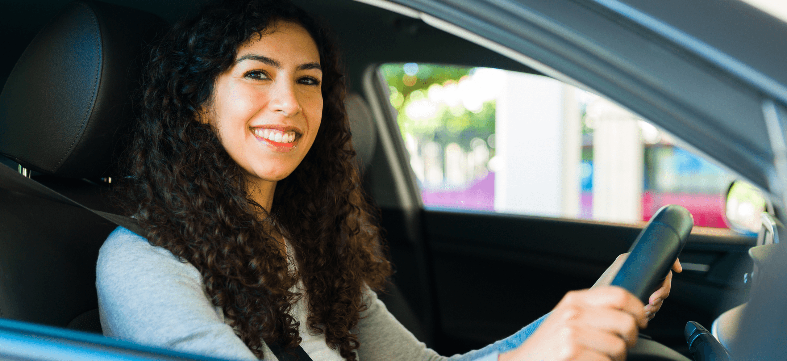 Happy its4women female driver behind wheel of car