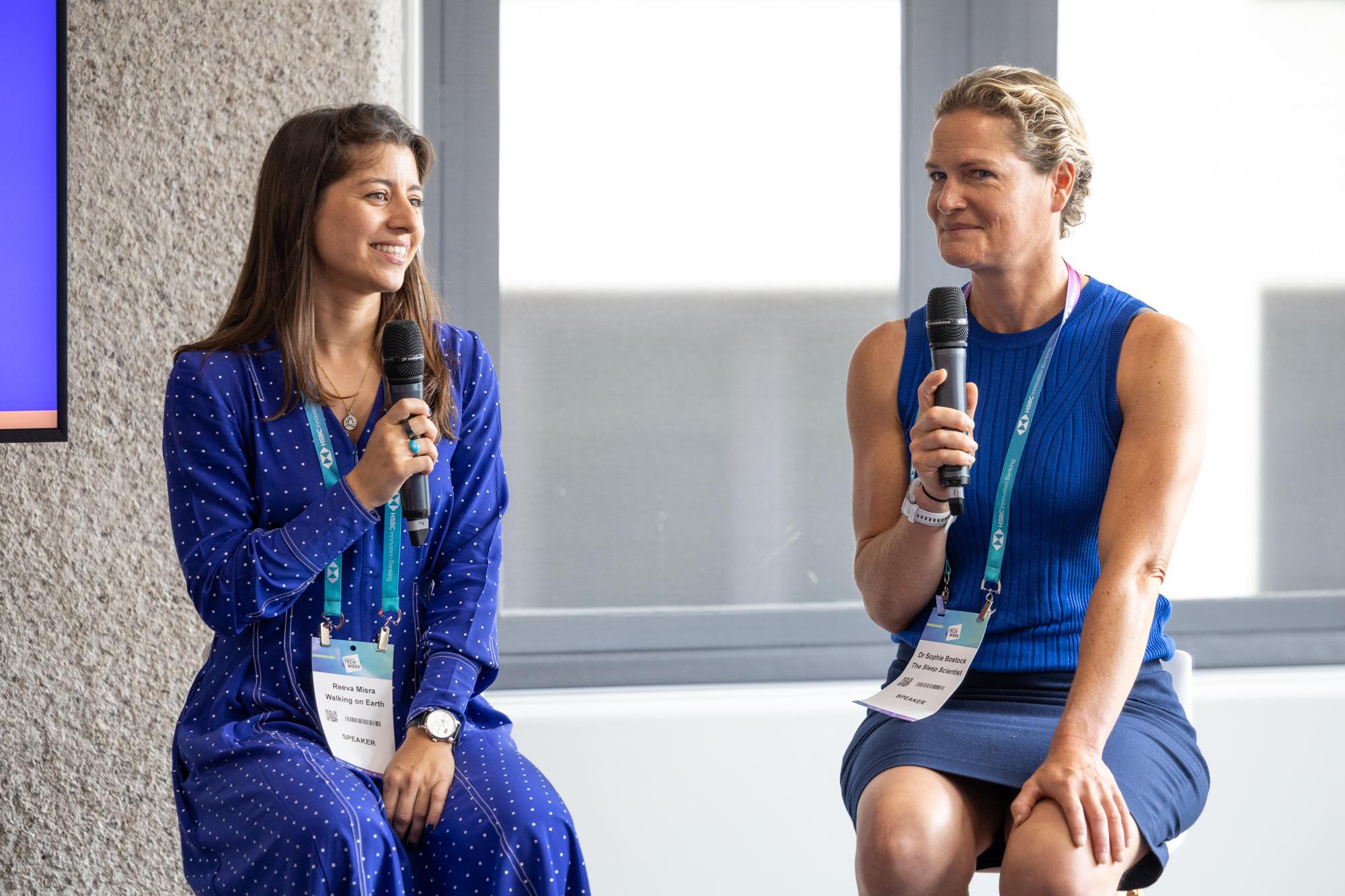 Two people speaking on a stage at an event