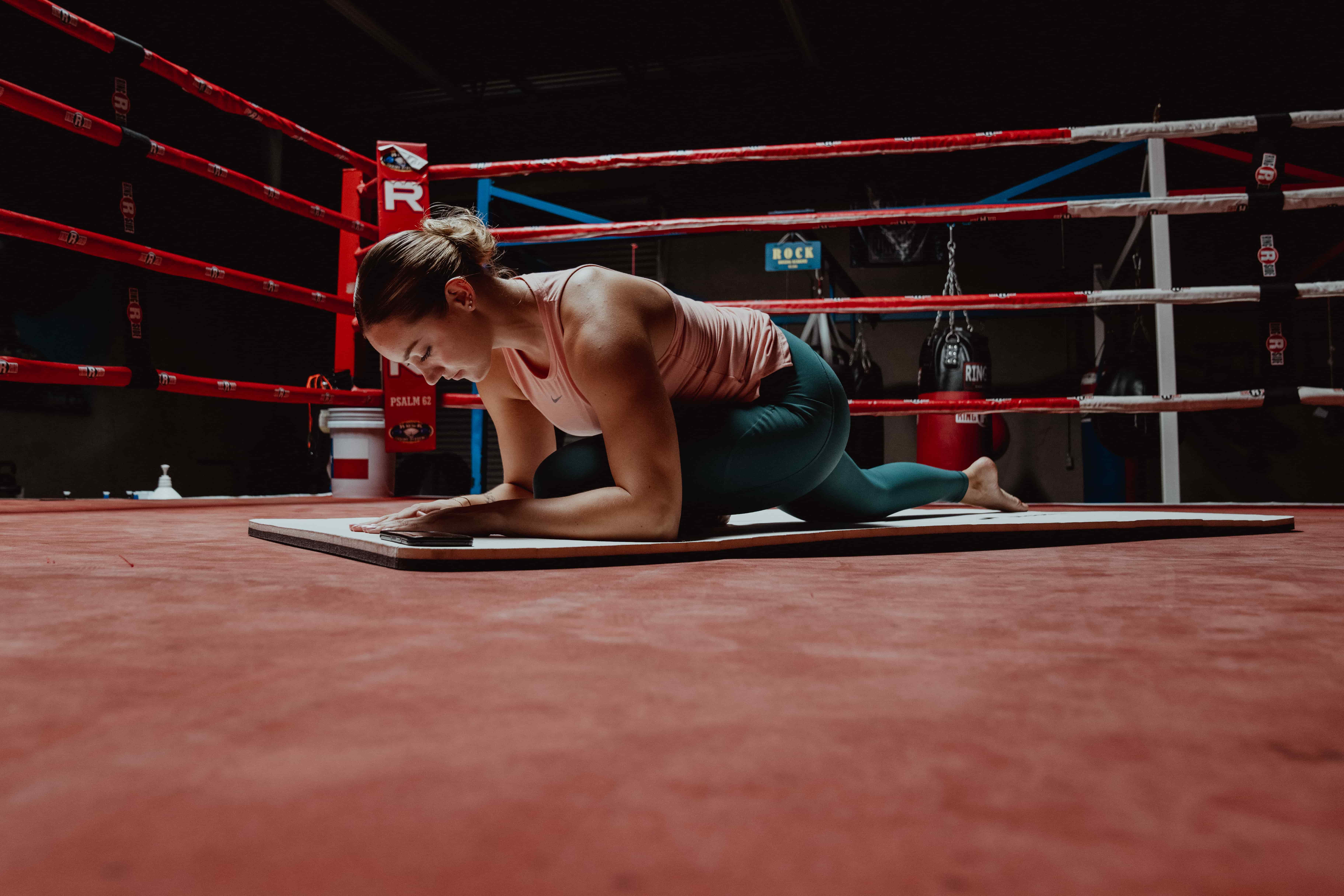 Woman Exercising in Boxing Ring - Back Mobility Exercises