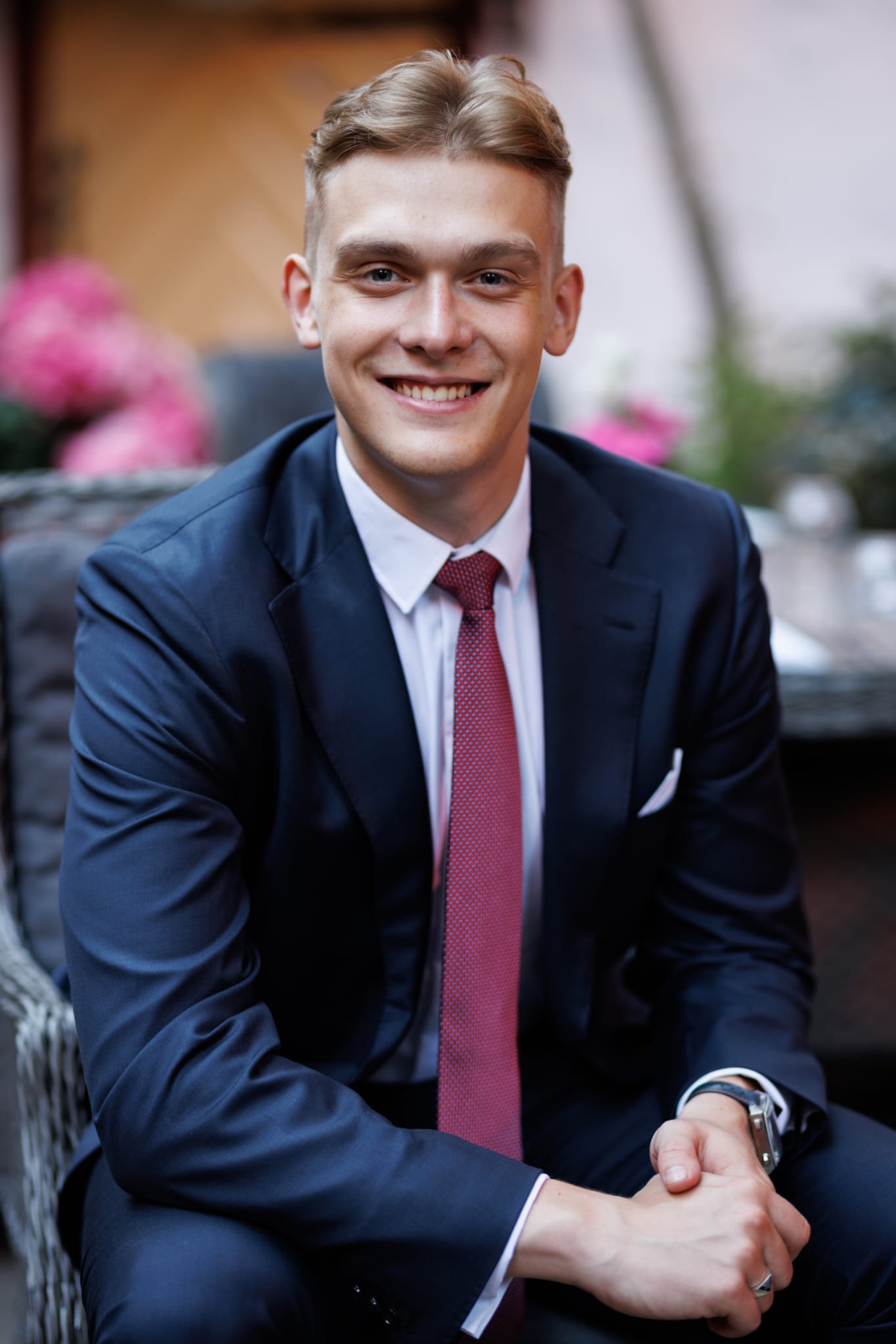 a man in a suit and tie sitting in a chair