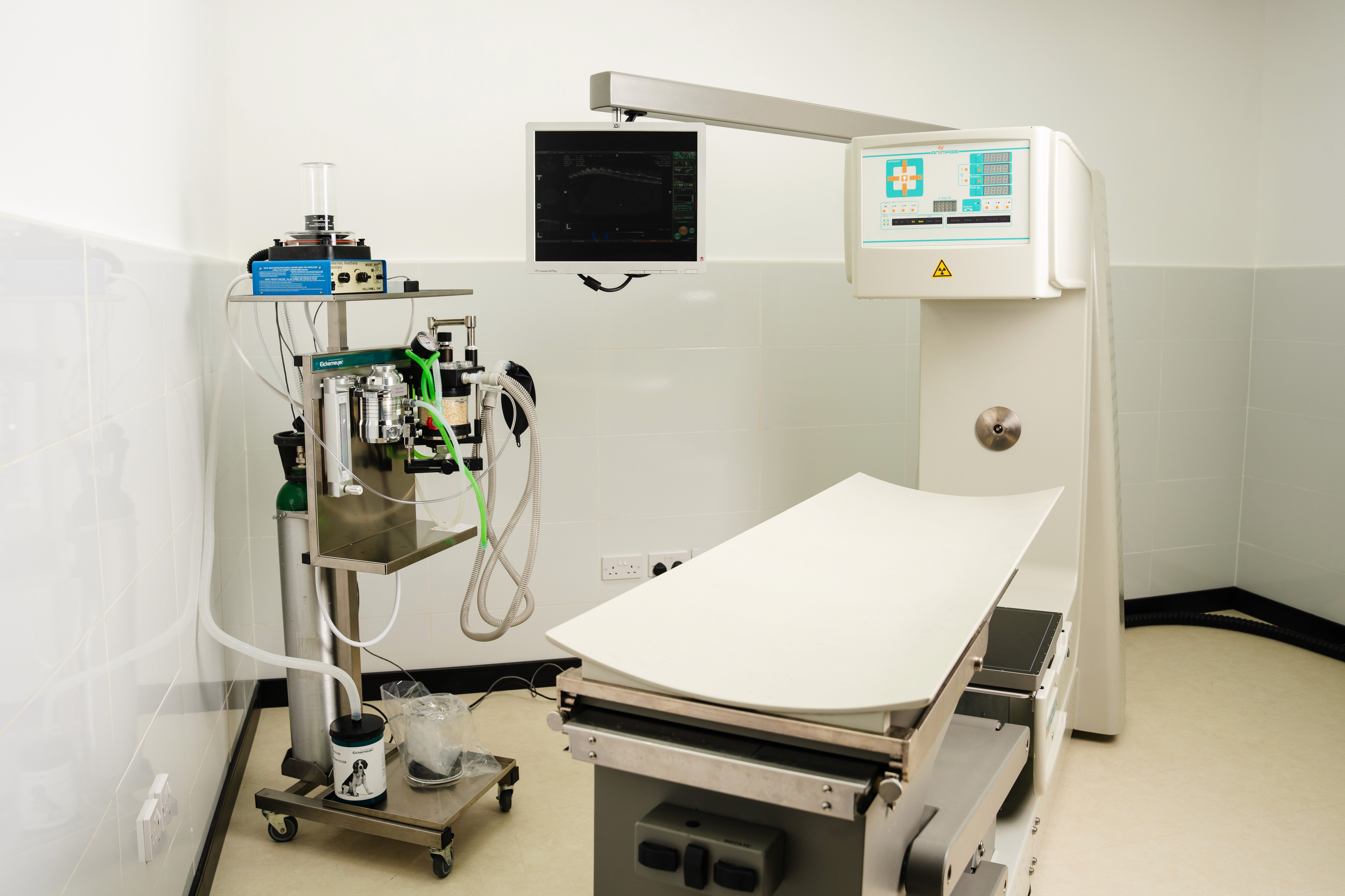 Veterinary X-ray equipment and monitoring machines in a clean examination room at Noble Vet Clinic in Dubai.