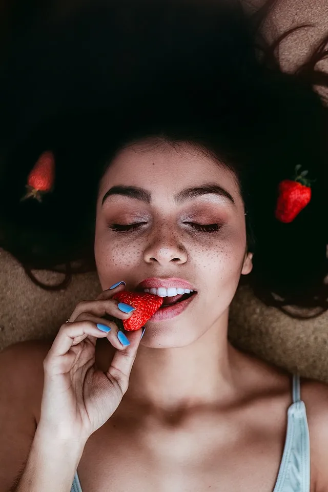 What you may notice when Zinc is in a good range - woman is eating strawberry