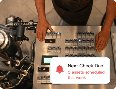 Technician inspecting machinery with a digital overlay showing “Next Check Due – 5 assets scheduled this week,” representing scheduled maintenance checks.