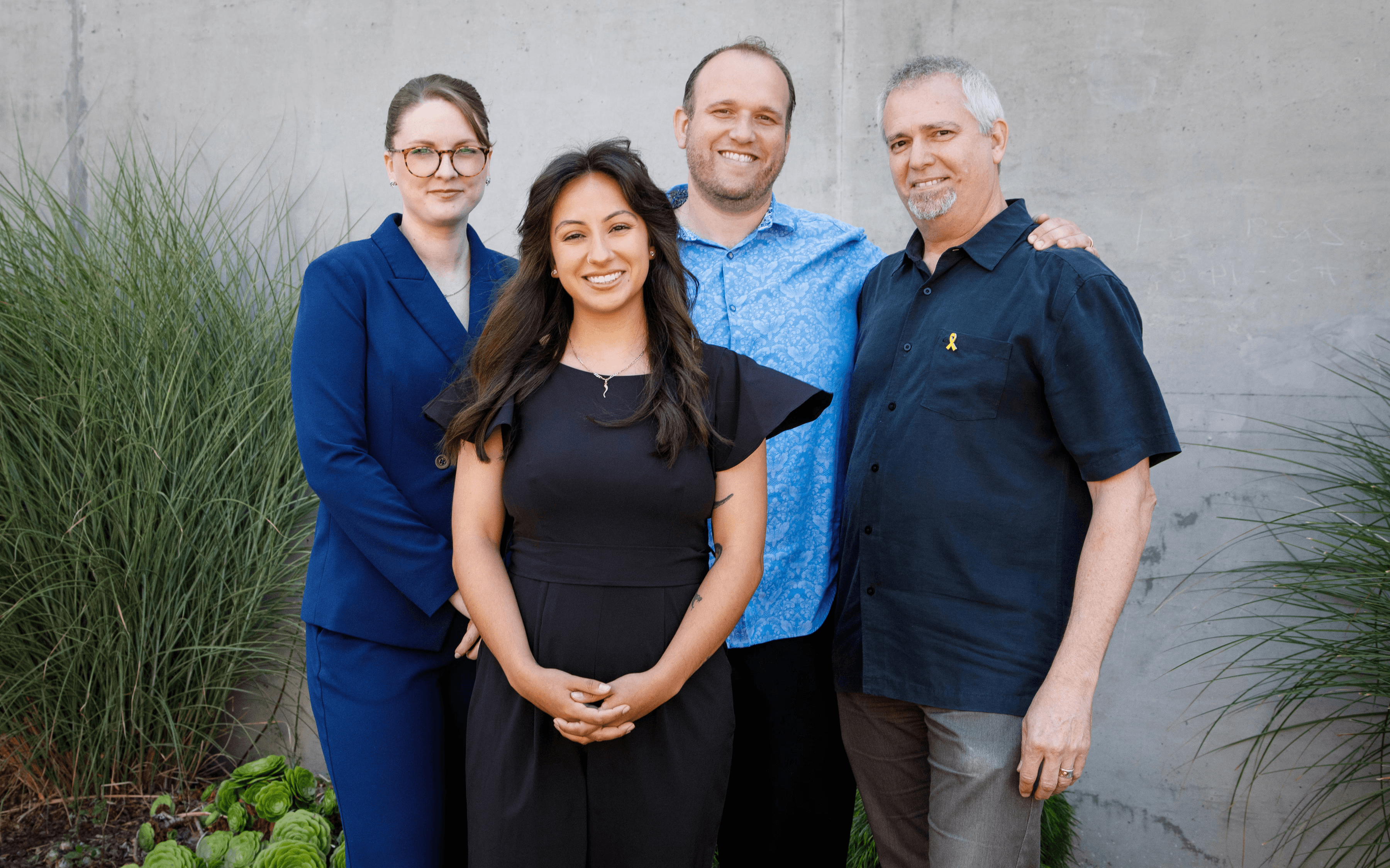 The audicles team in front of the Name Sign