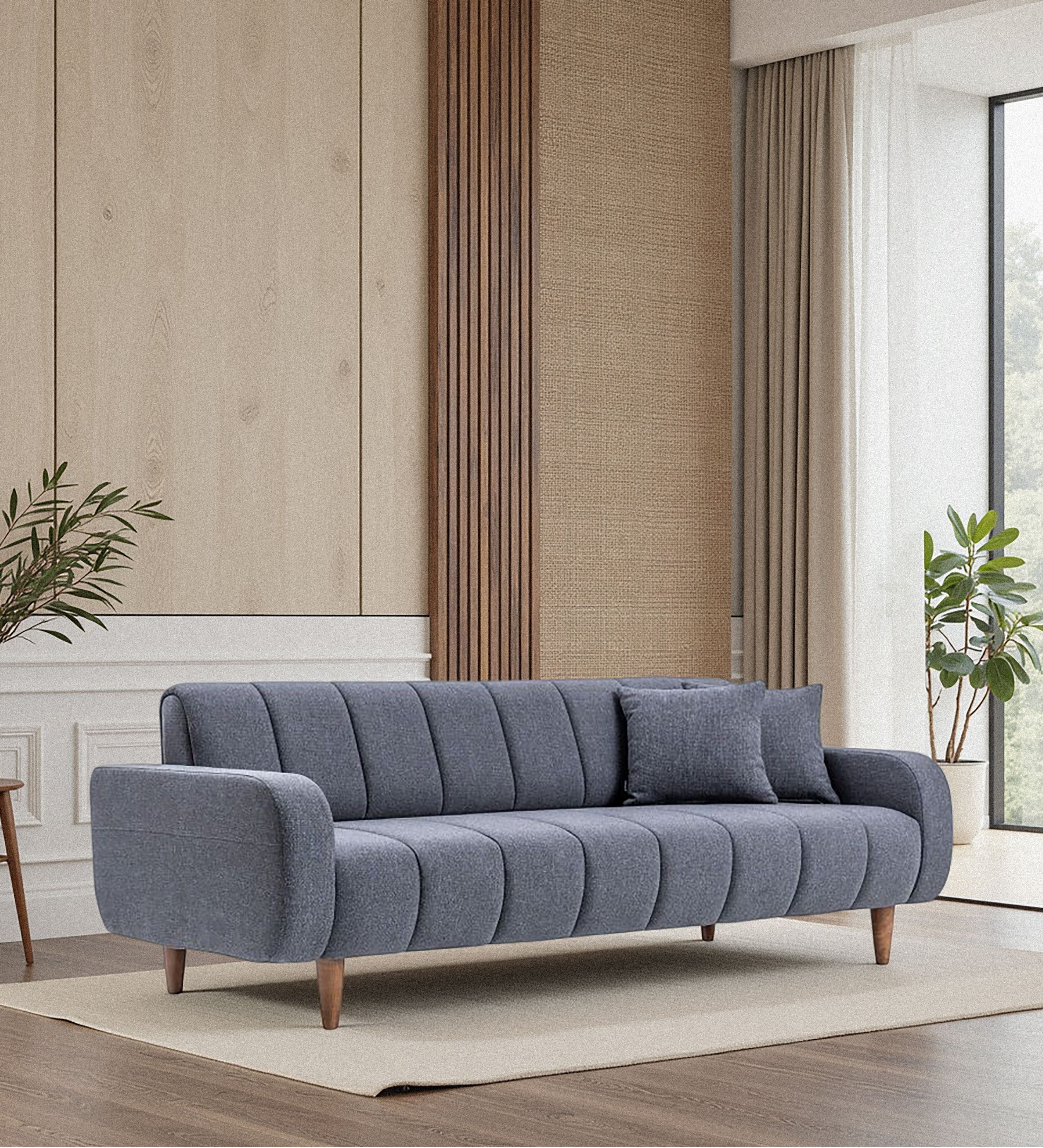 Channel-stitched blue fabric seating with rounded arms and tapered wooden legs