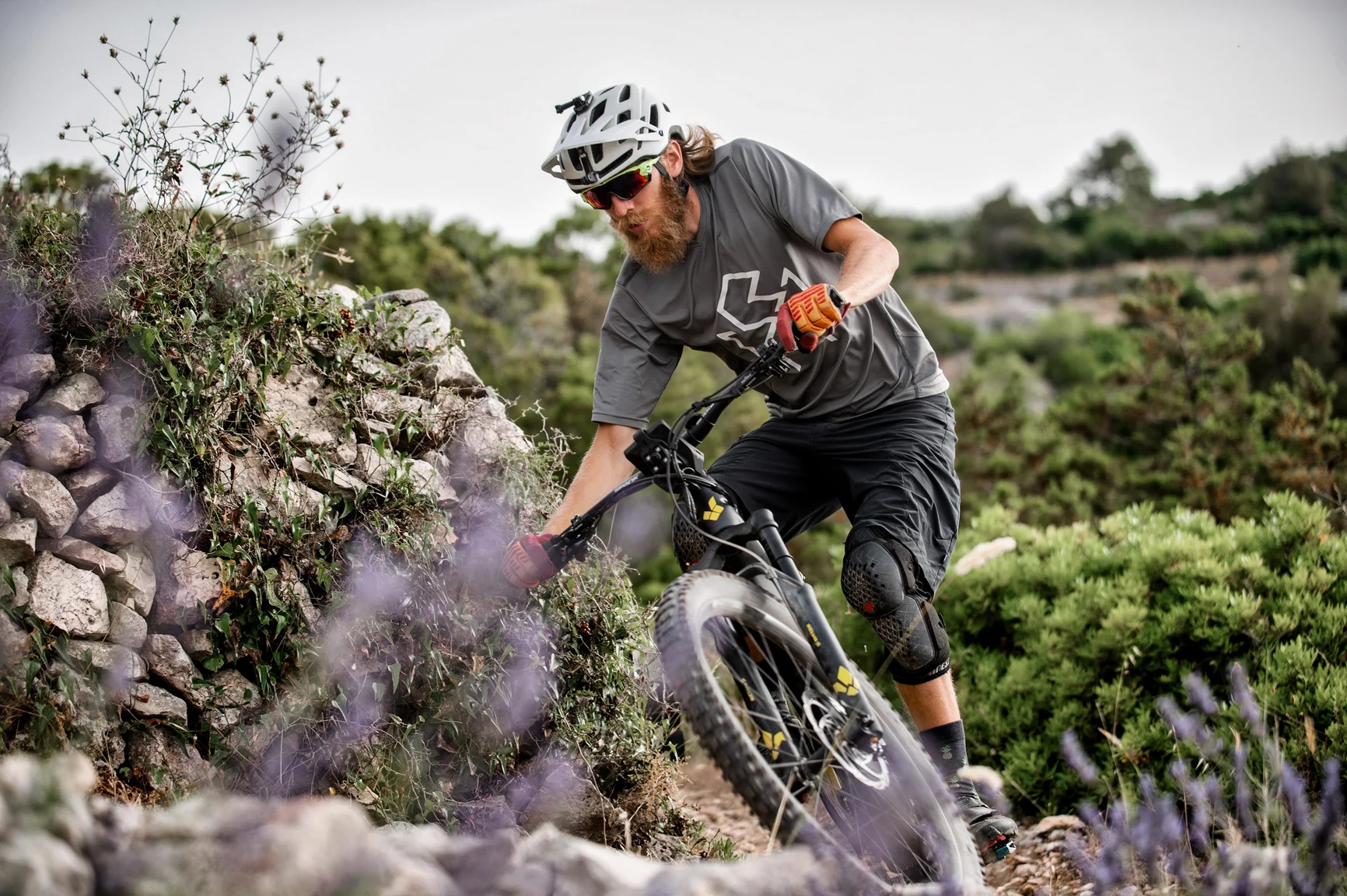 Man on e mountain bike riding outdoors.