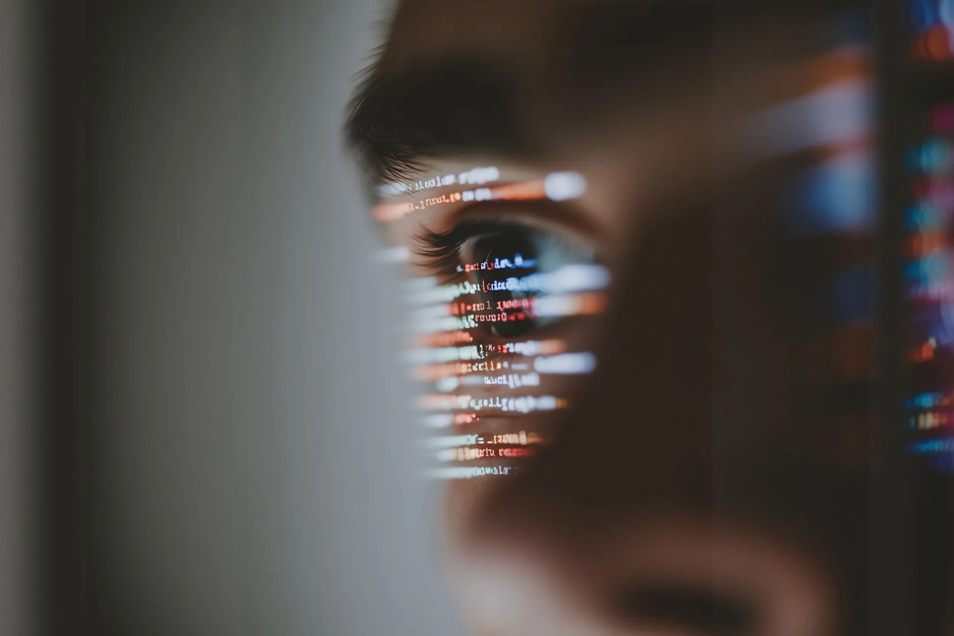 A close-up of code reflected in an eye.