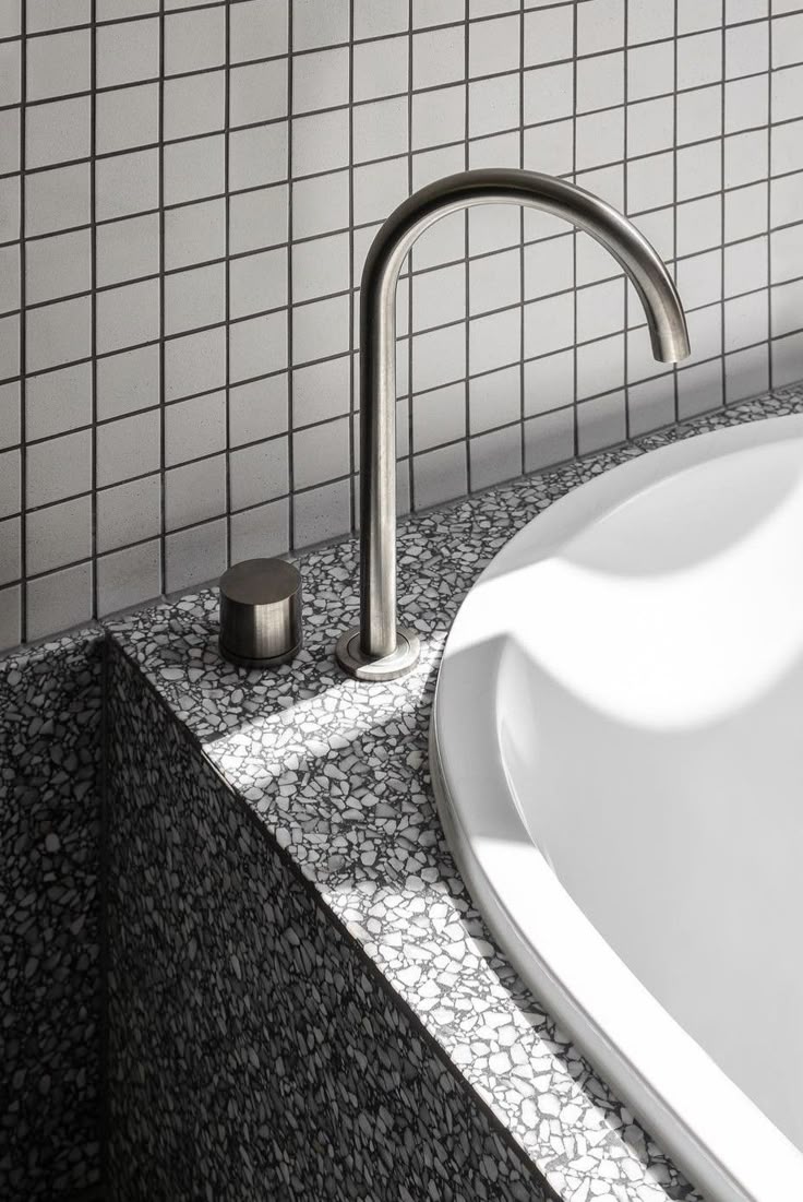 Large-format stone tiles in a minimalist bathroom, waterproofed and installed by QUARTA in Melbourne.