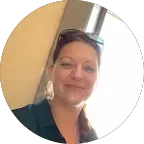 A person in a white shirt black coat with the fair skin looking infront