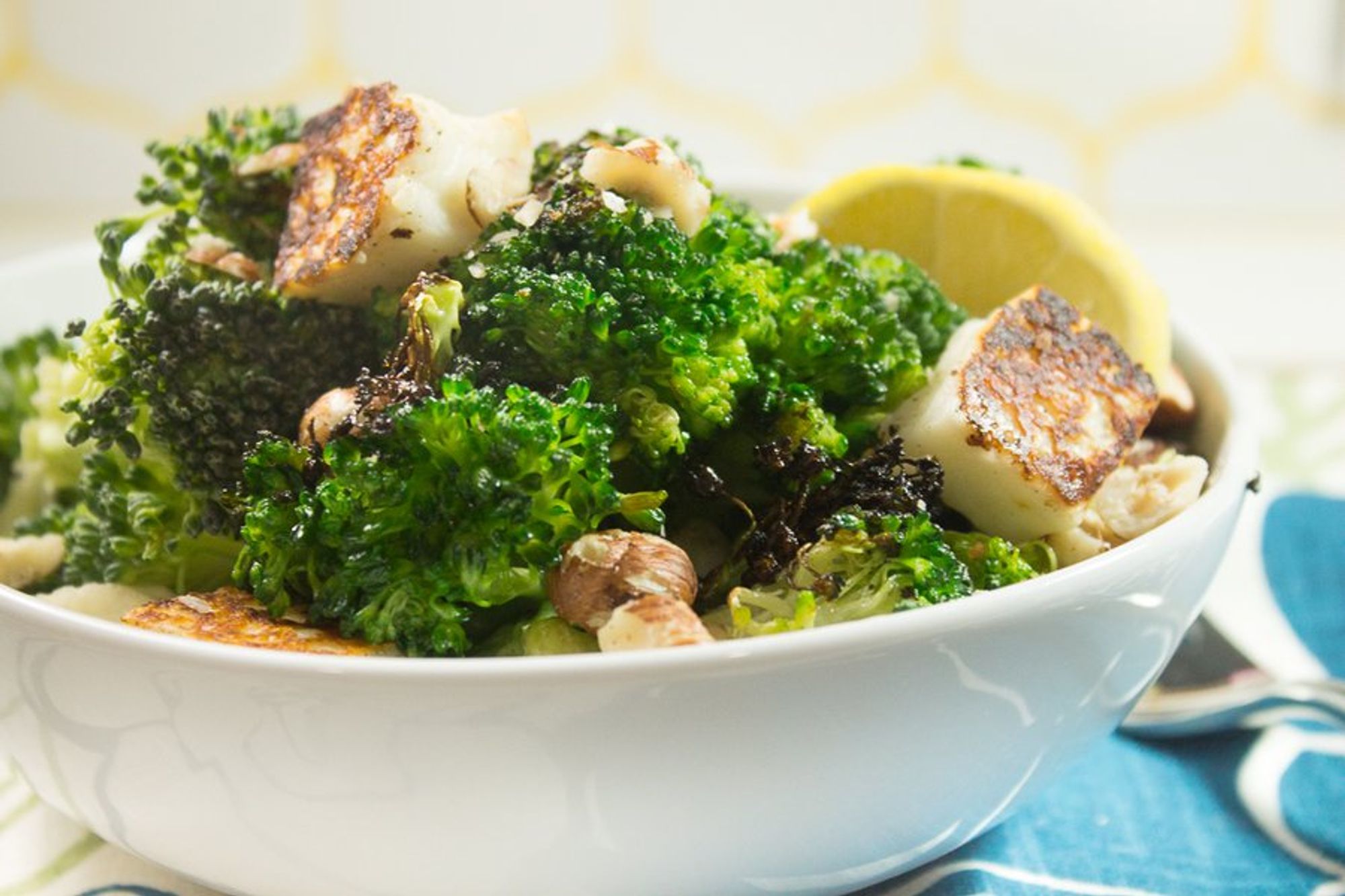 roasted broccoli with halloumi and hazelnuts in a bowl