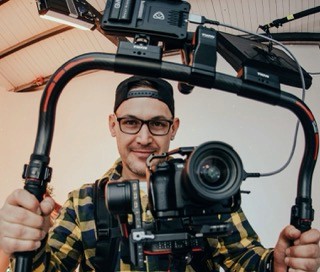 Videographer holding a camera stabilizer