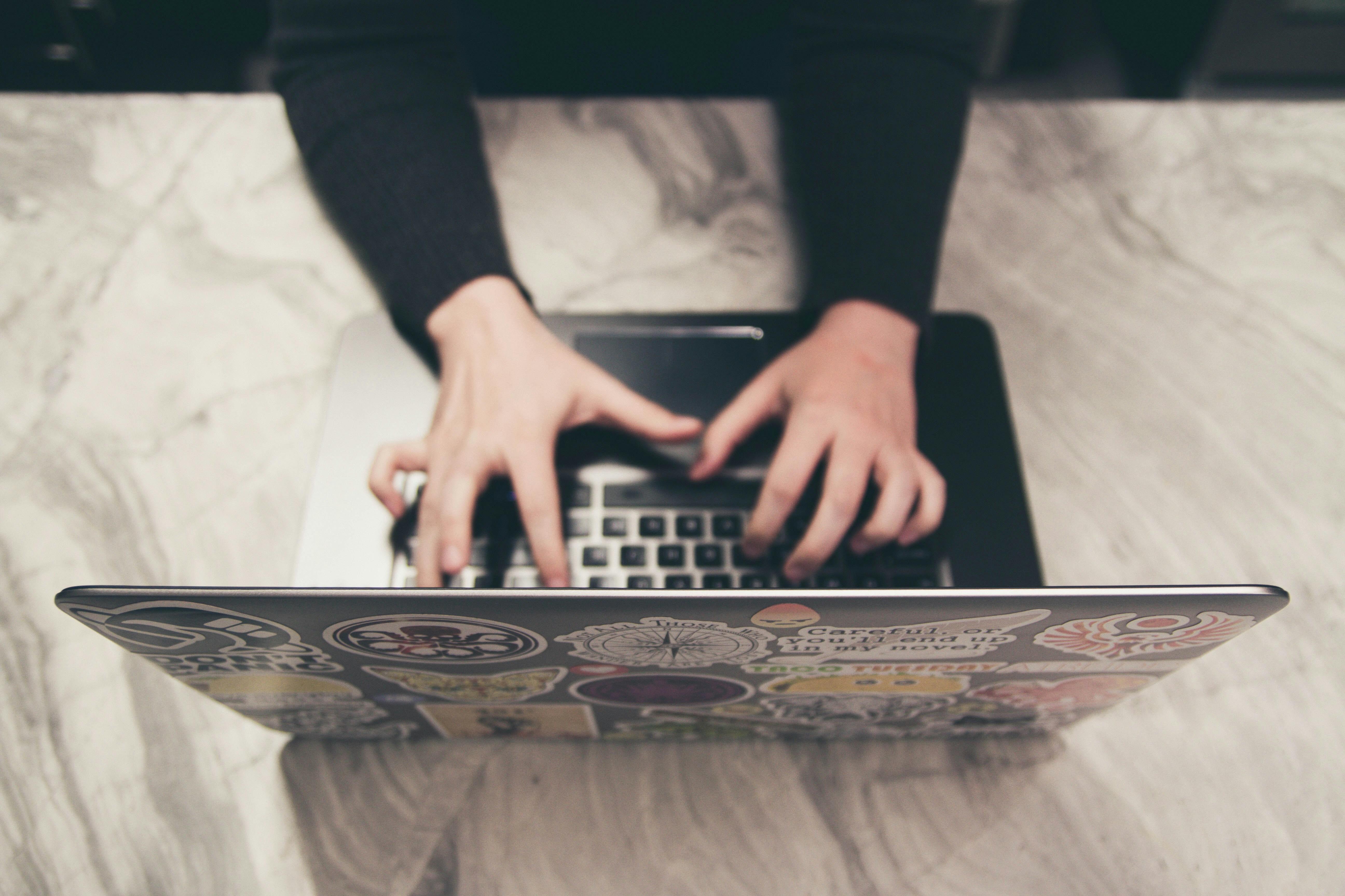 Male hands writing on a Laptop