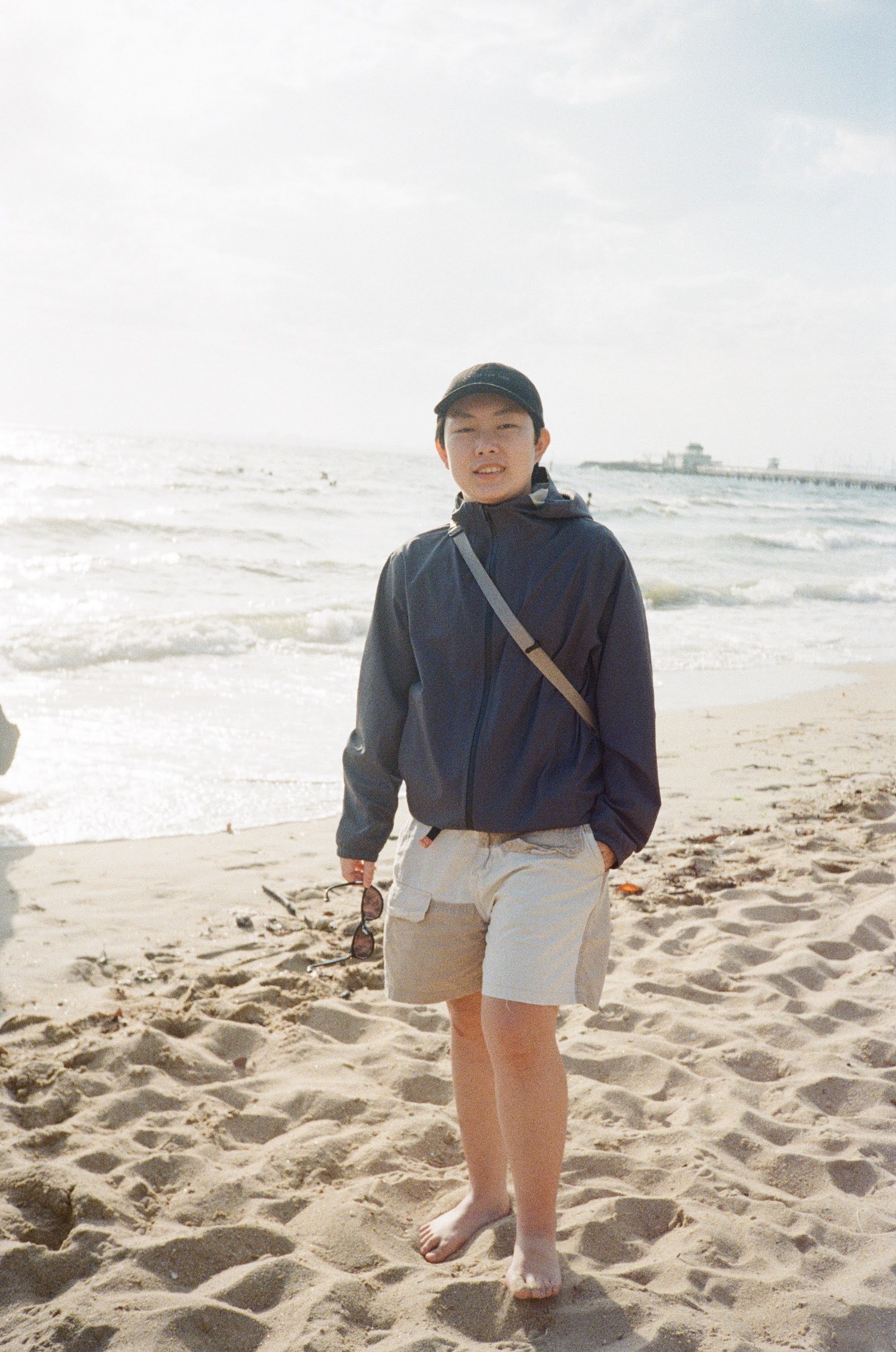 man in white dress shirt and black pants sitting on couch using Surface laptop