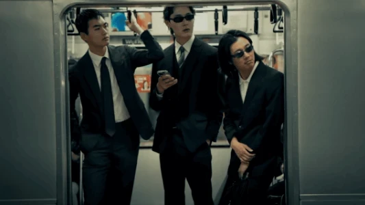 3 men in suits looking through a metro doorway