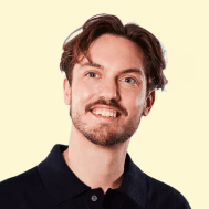 Close-up portrait of a young woman with long brown hair and blue eyes.