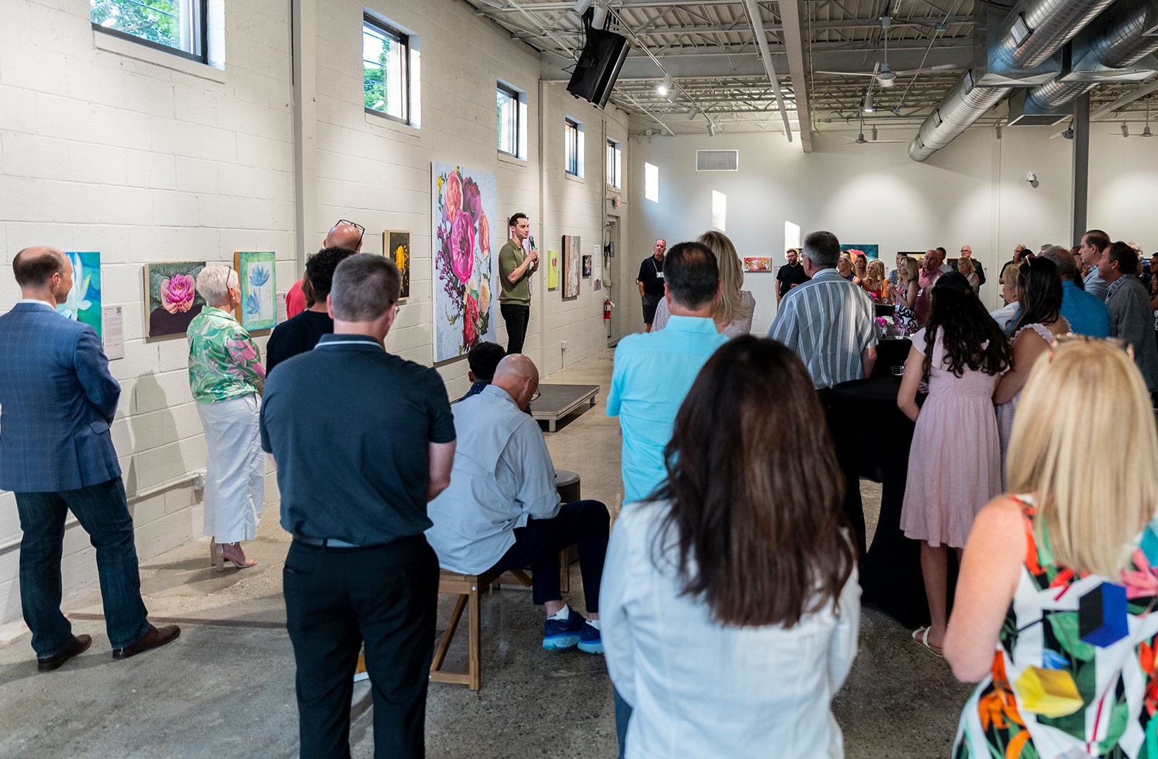 A crowd gathered at the faces of our daughters art gallery