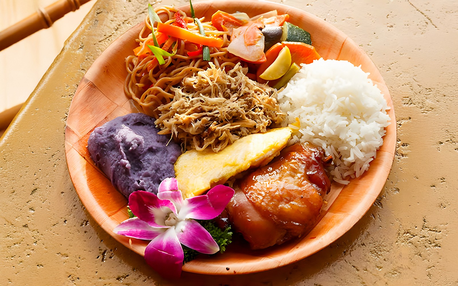 Imu-roasted dishes with rice, noodles, and purple sweet potato at Luau Kalamaku buffet.