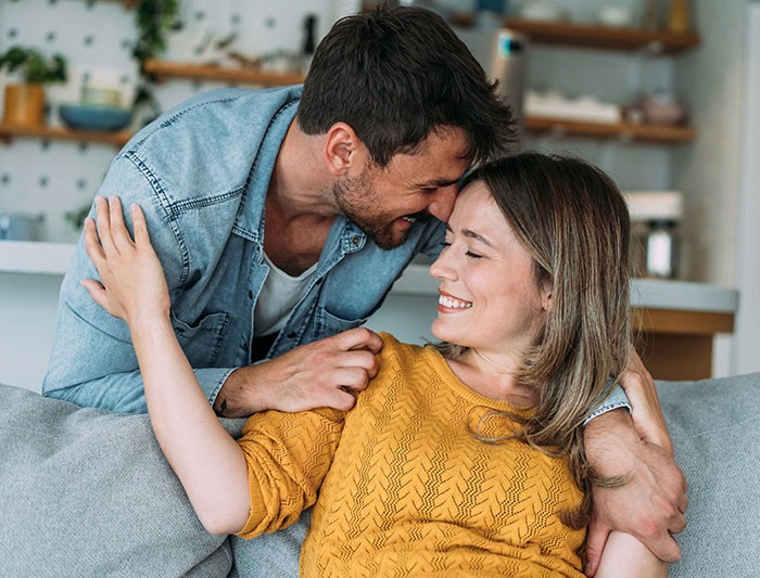 man and woman pressing heads together